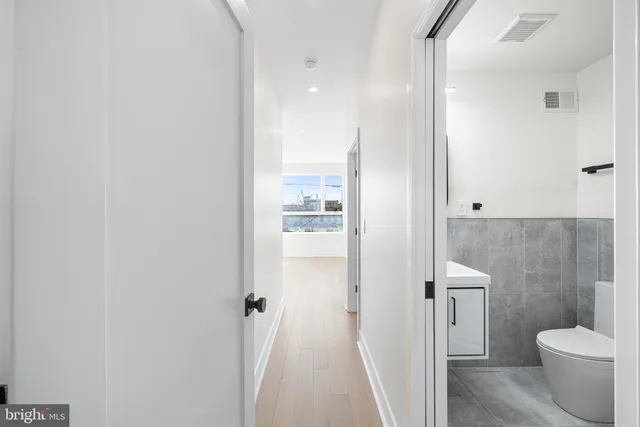 a bathroom with a granite countertop shower a toilet and a sink