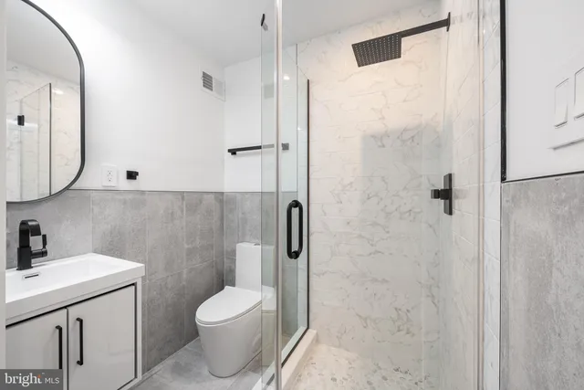 a bathroom with a toilet sink and shower