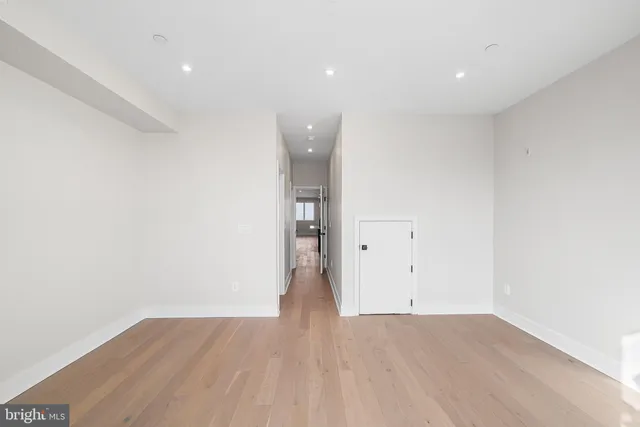 an empty room with wooden floor