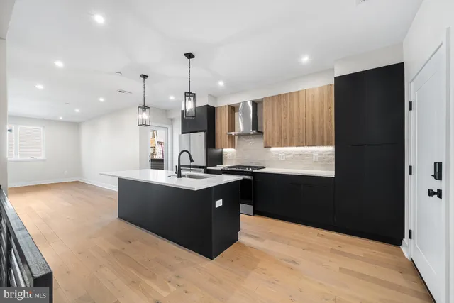 a large kitchen with kitchen island granite countertop a sink and a stove