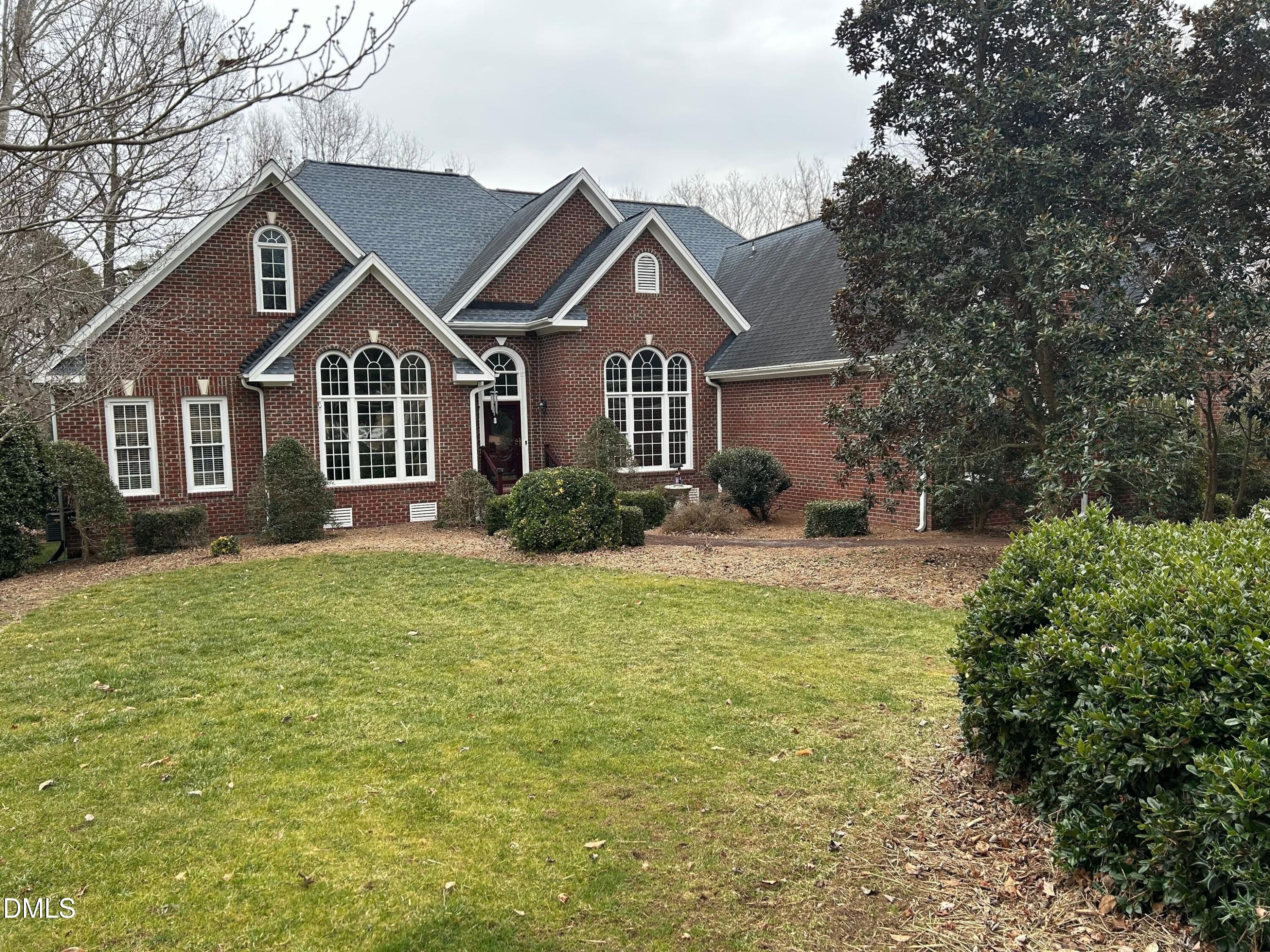 a front view of a house with a garden