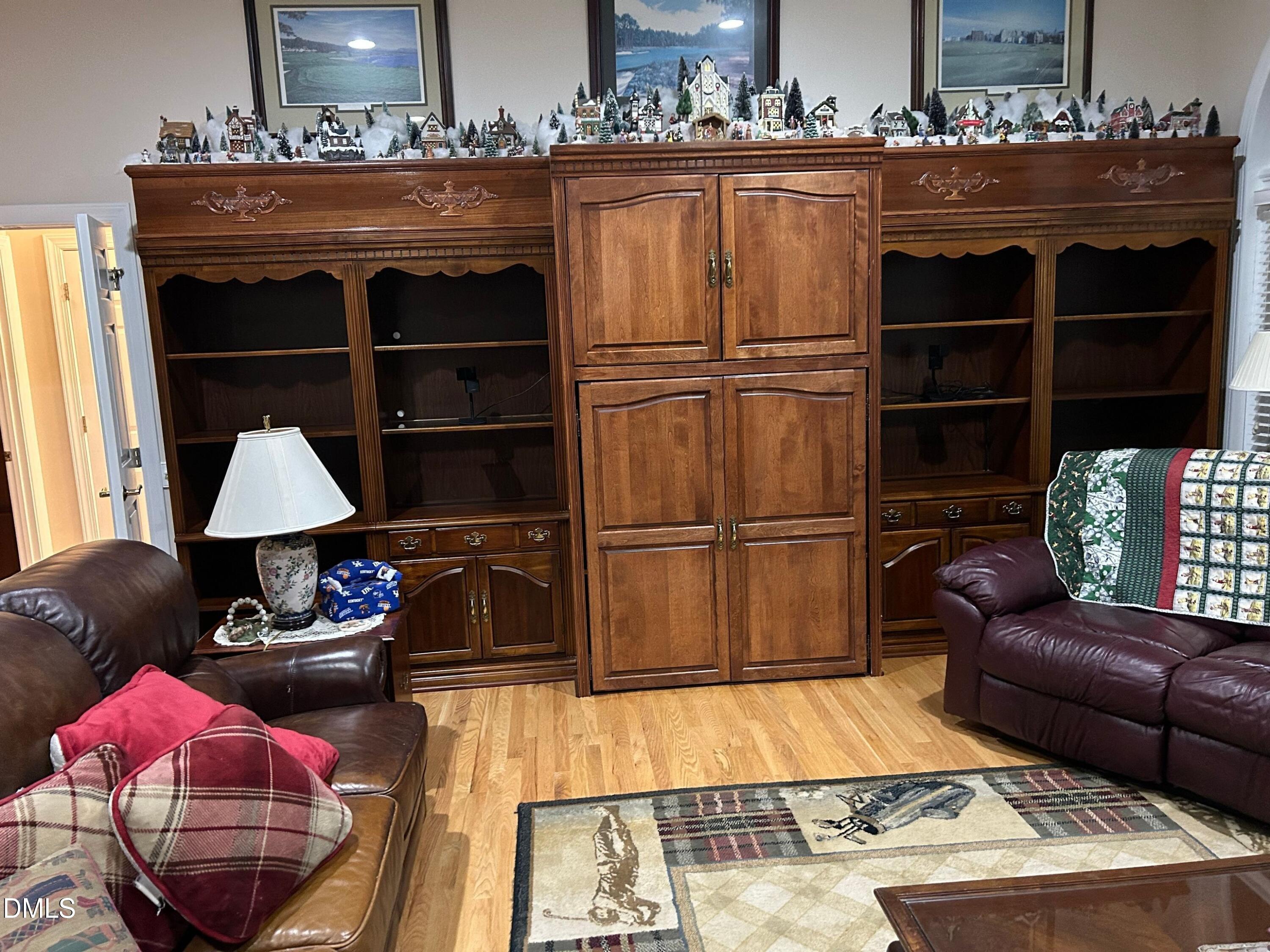 3608 Pauley Court Raleigh, NC 27610 - Photo 12 of 48 a living room with furniture a rug and wall paintings