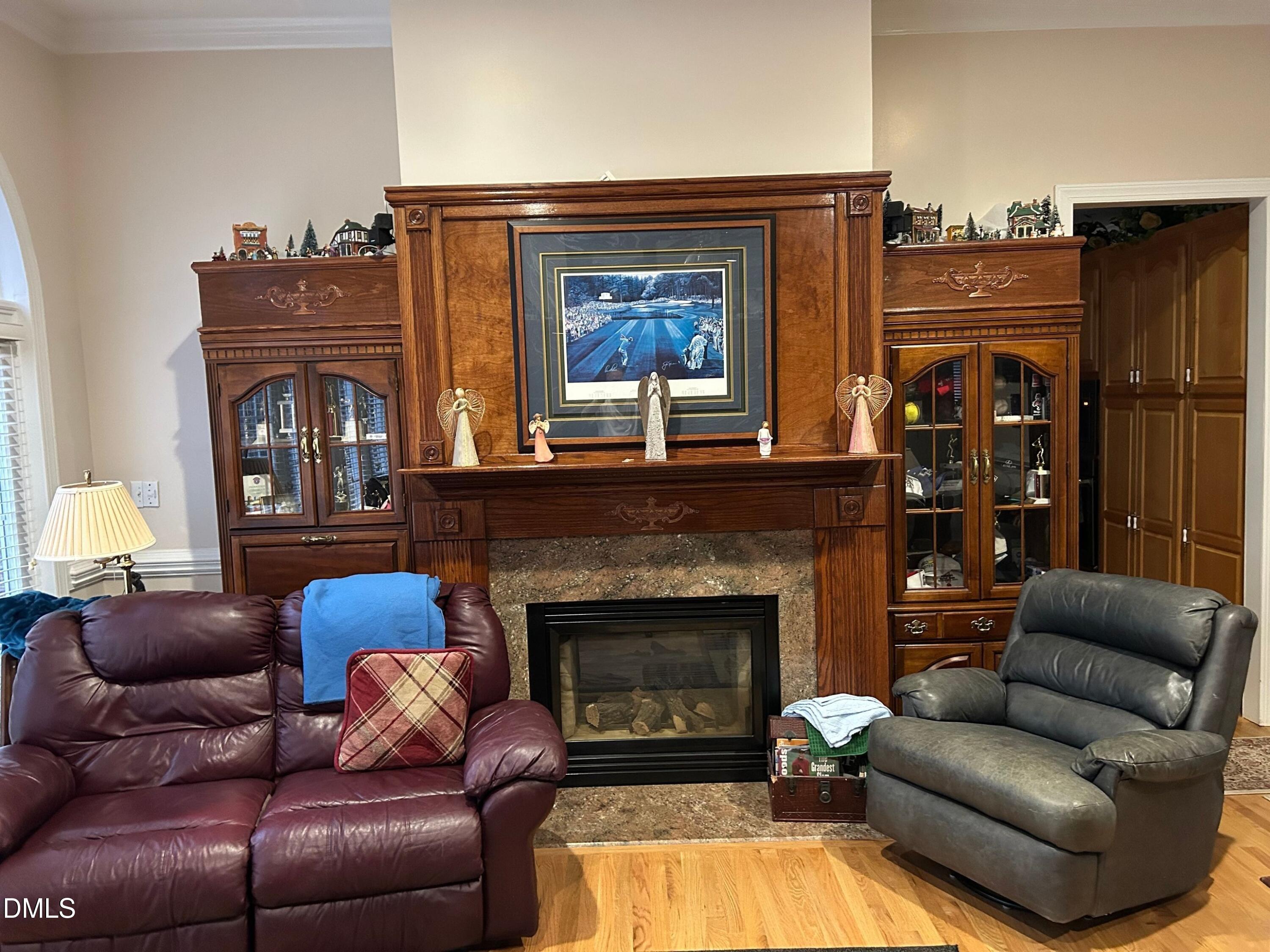 3608 Pauley Court Raleigh, NC 27610 - Photo 14 of 48 a living room with furniture a fireplace and a flat screen tv