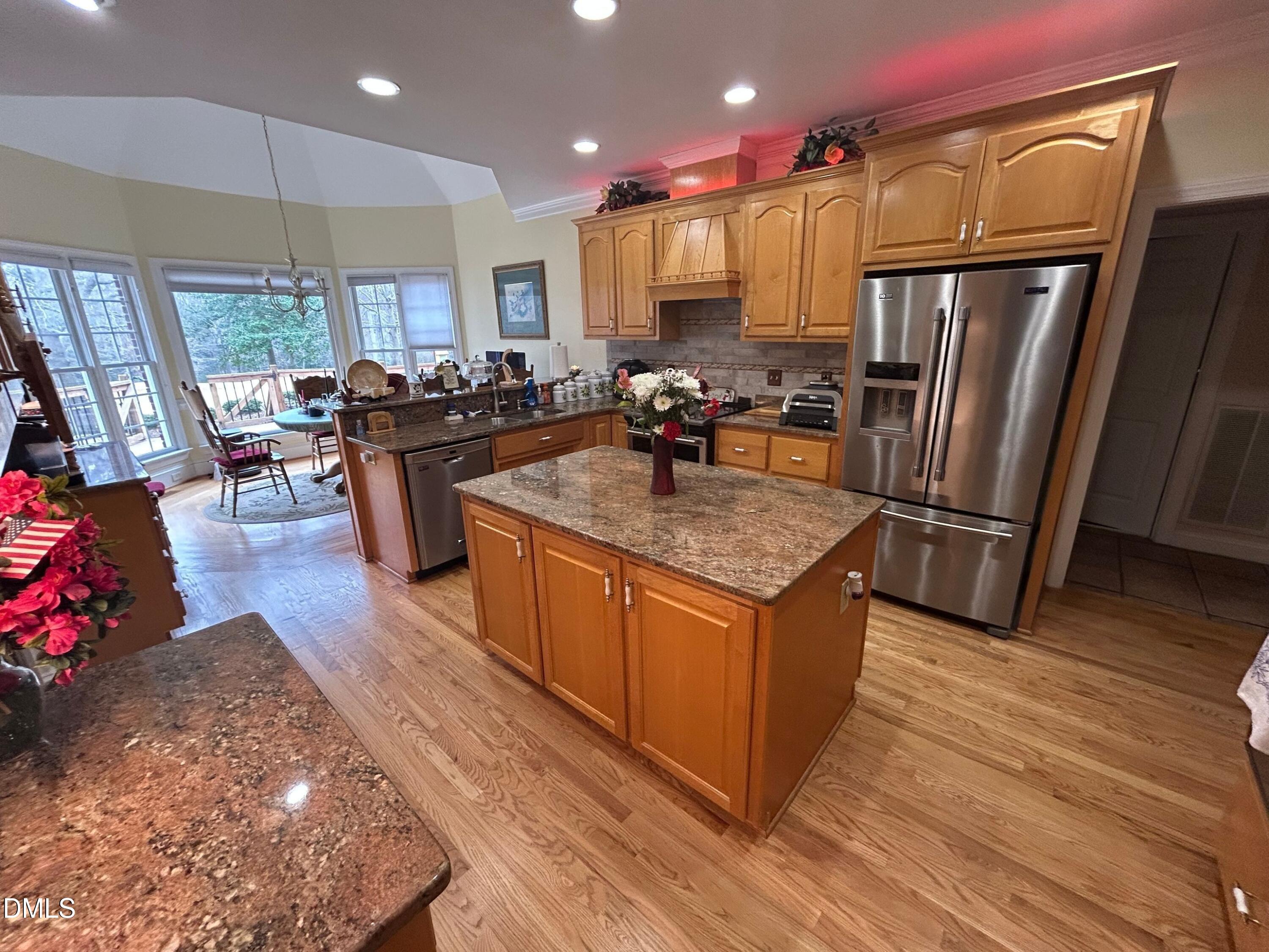 3608 Pauley Court Raleigh, NC 27610 - Photo 20 of 48 a kitchen with stainless steel appliances granite countertop a refrigerator a sink and a stove