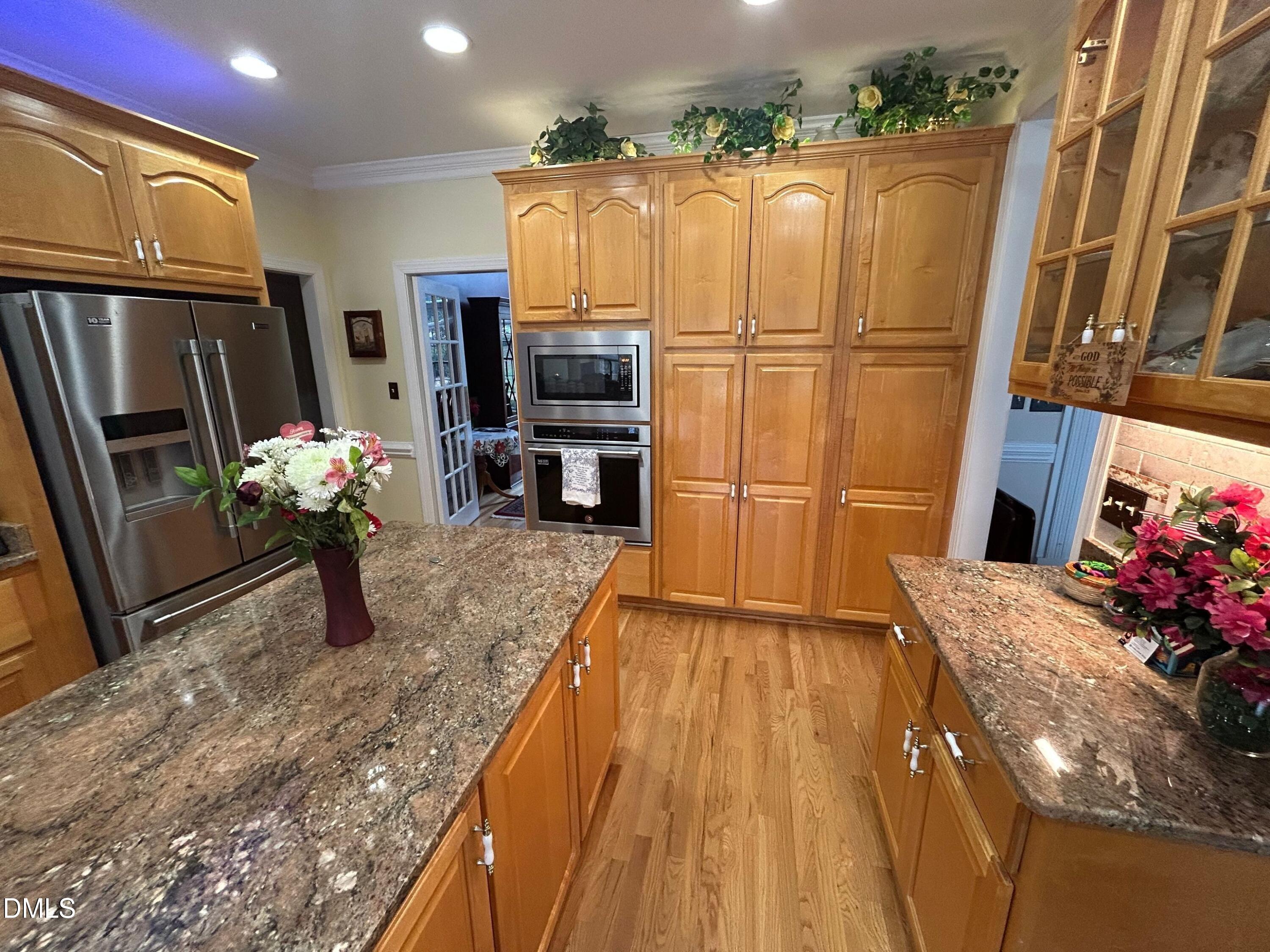 3608 Pauley Court Raleigh, NC 27610 - Photo 21 of 48 a kitchen with sink refrigerator and microwave