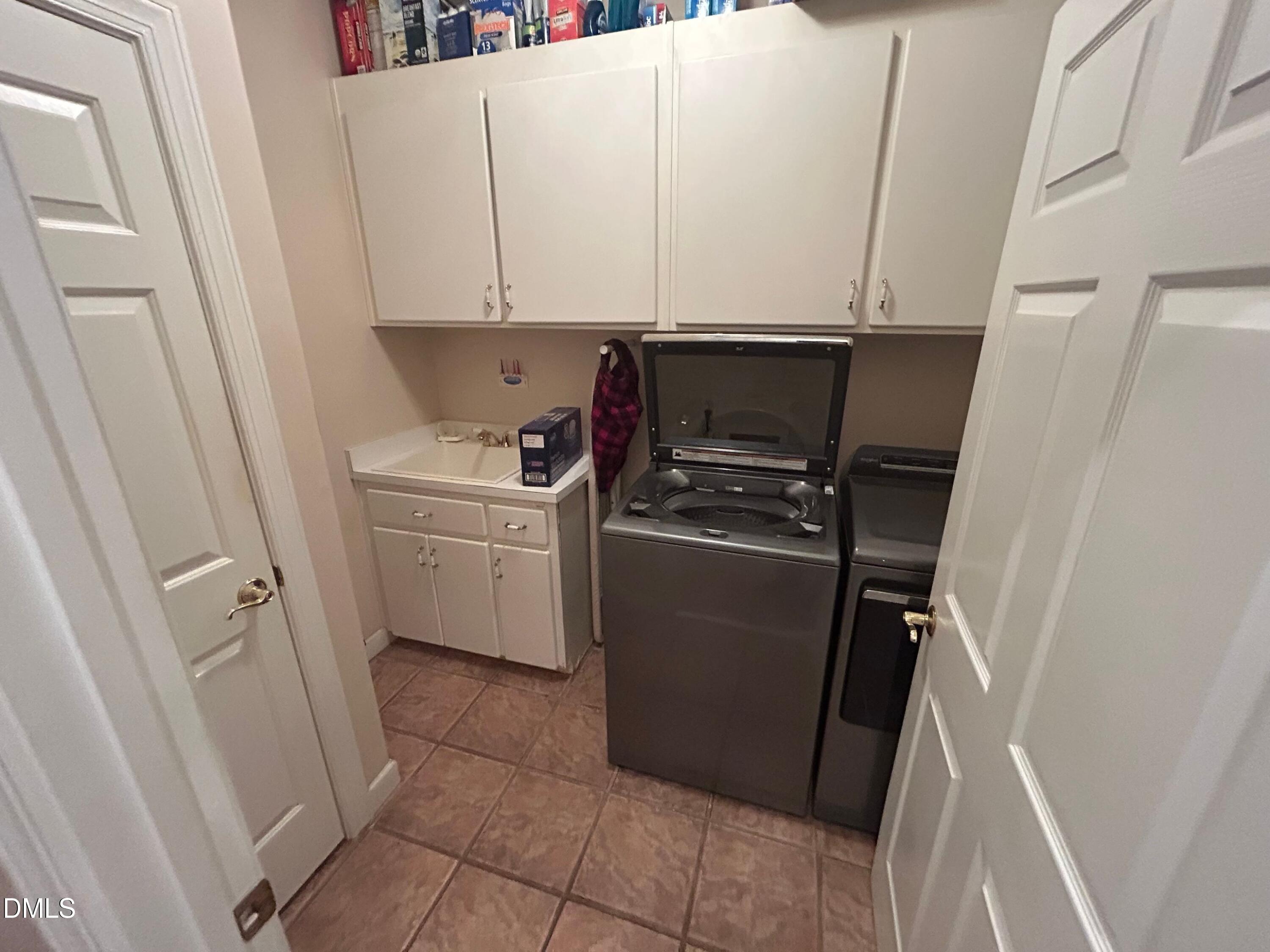 3608 Pauley Court Raleigh, NC 27610 - Photo 26 of 48 a utility room with cabinets washer and dryer