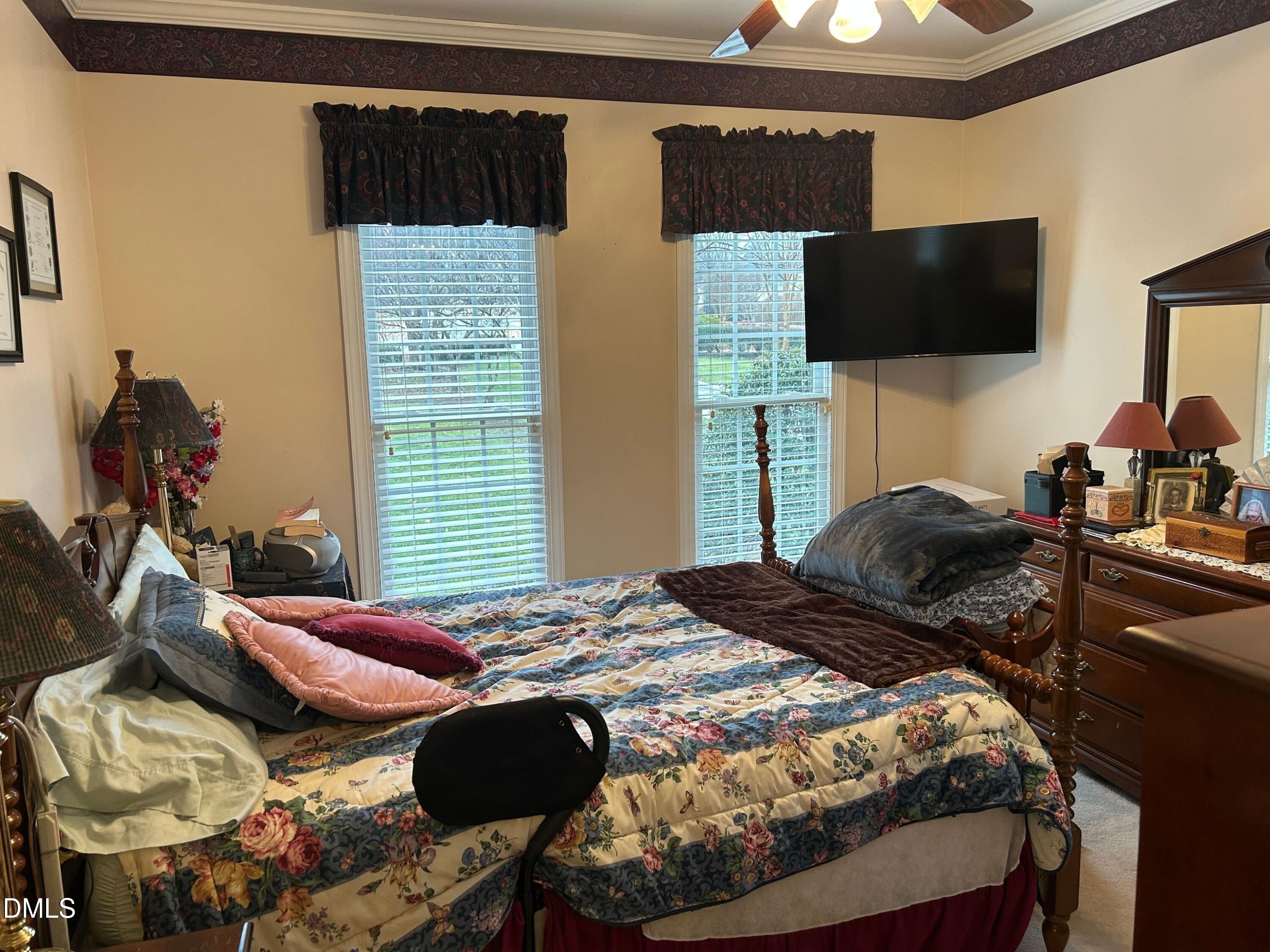 3608 Pauley Court Raleigh, NC 27610 - Photo 41 of 48 a bedroom with a bed tv and a window