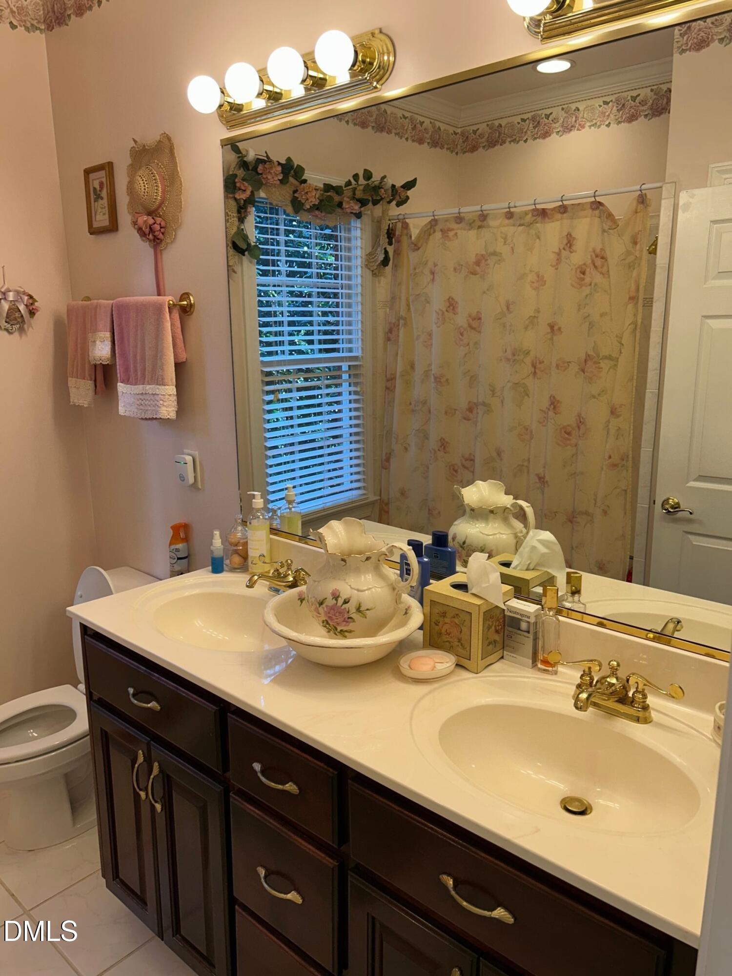 3608 Pauley Court Raleigh, NC 27610 - Photo 45 of 48 a bathroom with a sink double vanity and a mirror