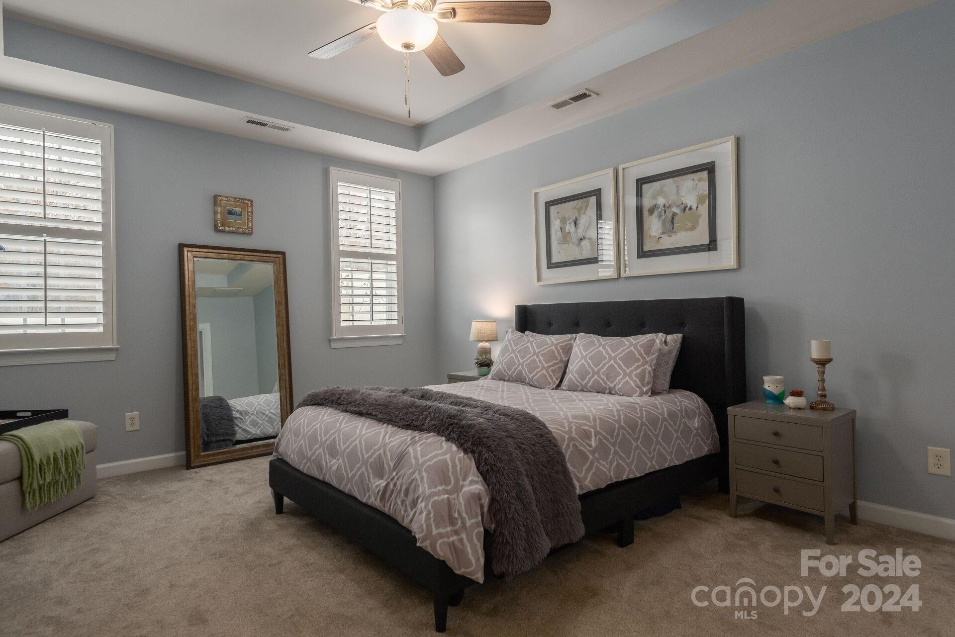 6725 Dusty Saddle Road Charlotte, NC 28277 - Photo 11 of 29 a spacious bedroom with a bed and a chandelier