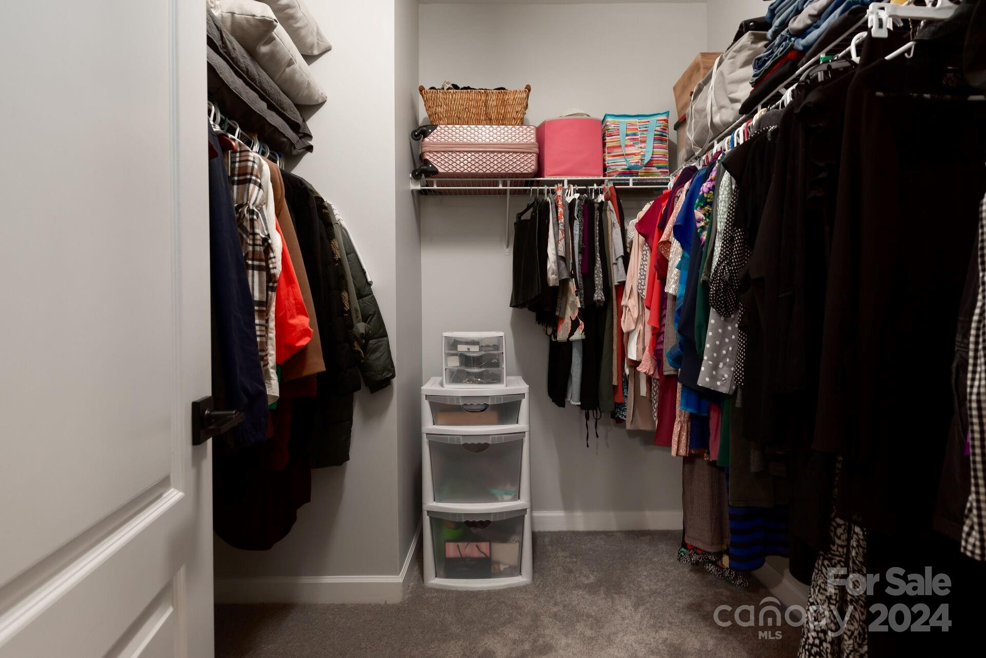 6725 Dusty Saddle Road Charlotte, NC 28277 - Photo 15 of 29 a view of walk in closet with clothes and shoes