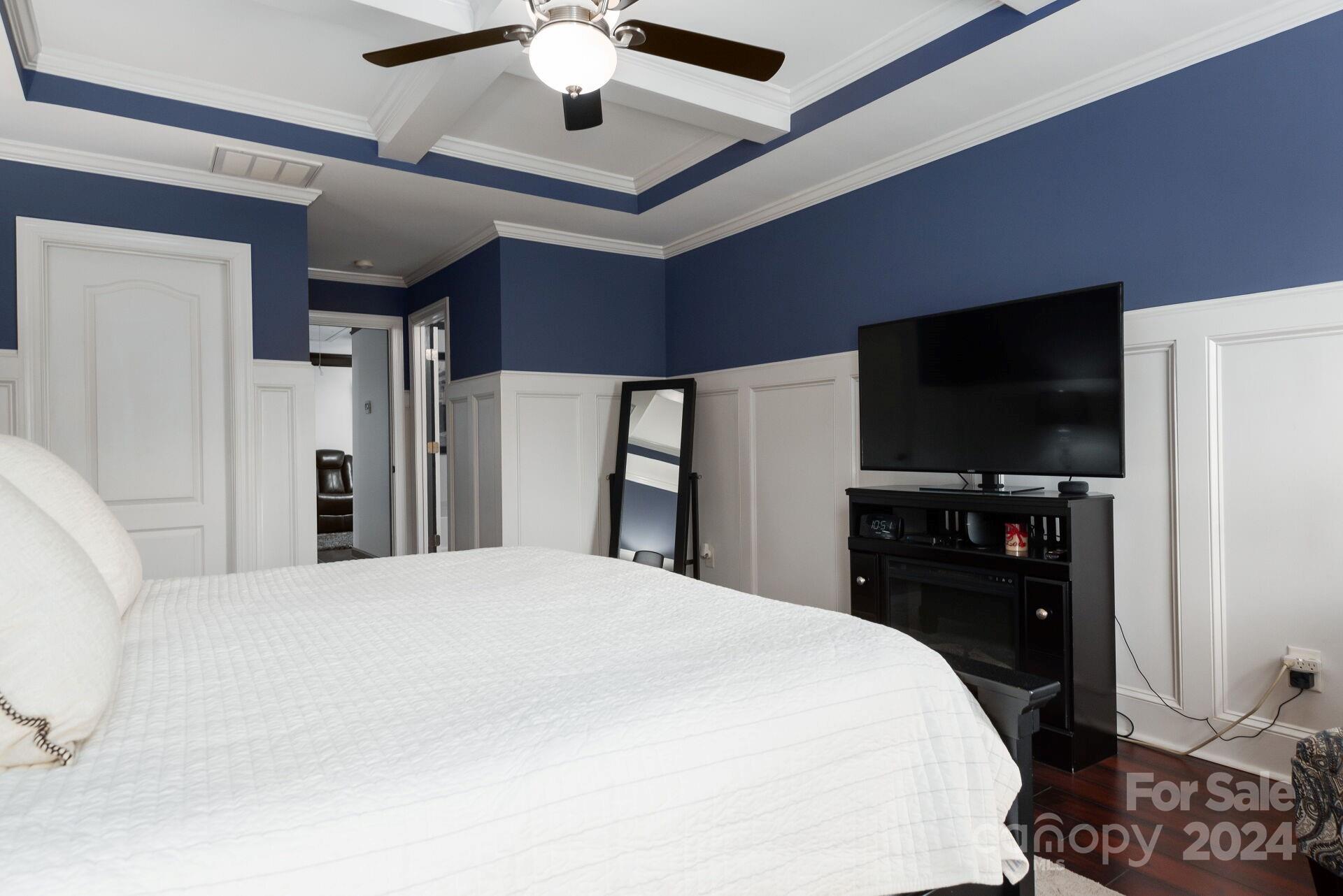 6725 Dusty Saddle Road Charlotte, NC 28277 - Photo 19 of 29 a large bedroom with a bed and a flat tv screen on dresser