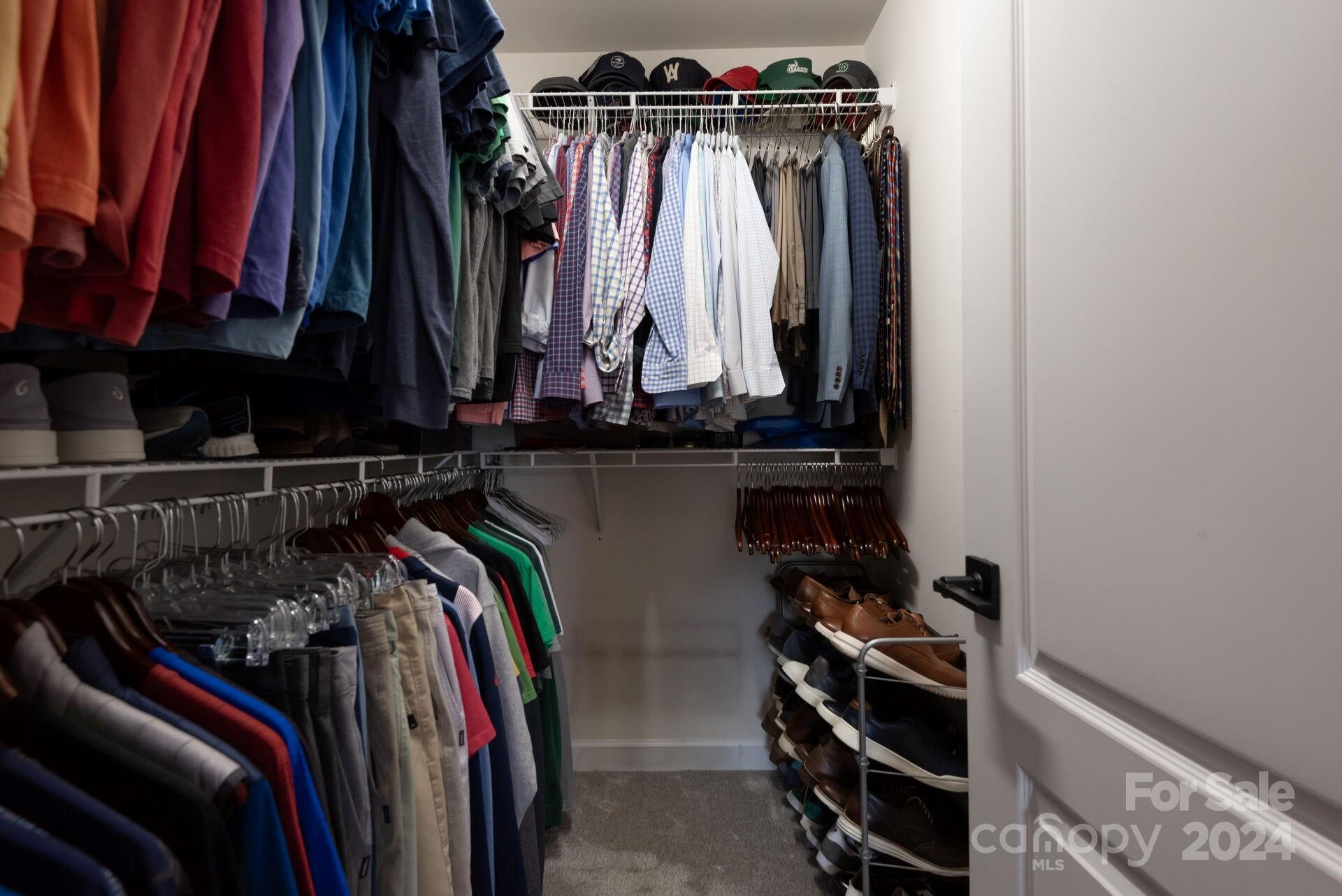 6725 Dusty Saddle Road Charlotte, NC 28277 - Photo 20 of 29 a view of walk in closet with clothes and shoes