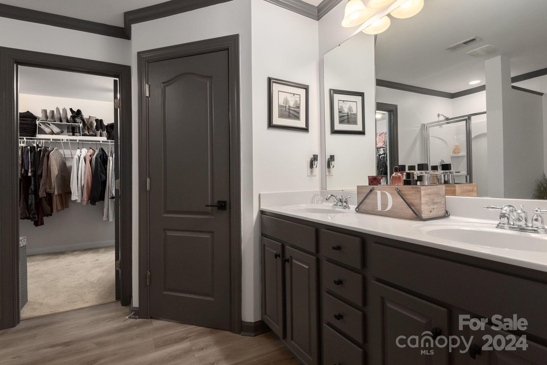 6725 Dusty Saddle Road Charlotte, NC 28277 - Photo 21 of 29 a bathroom with a double vanity sink and mirror