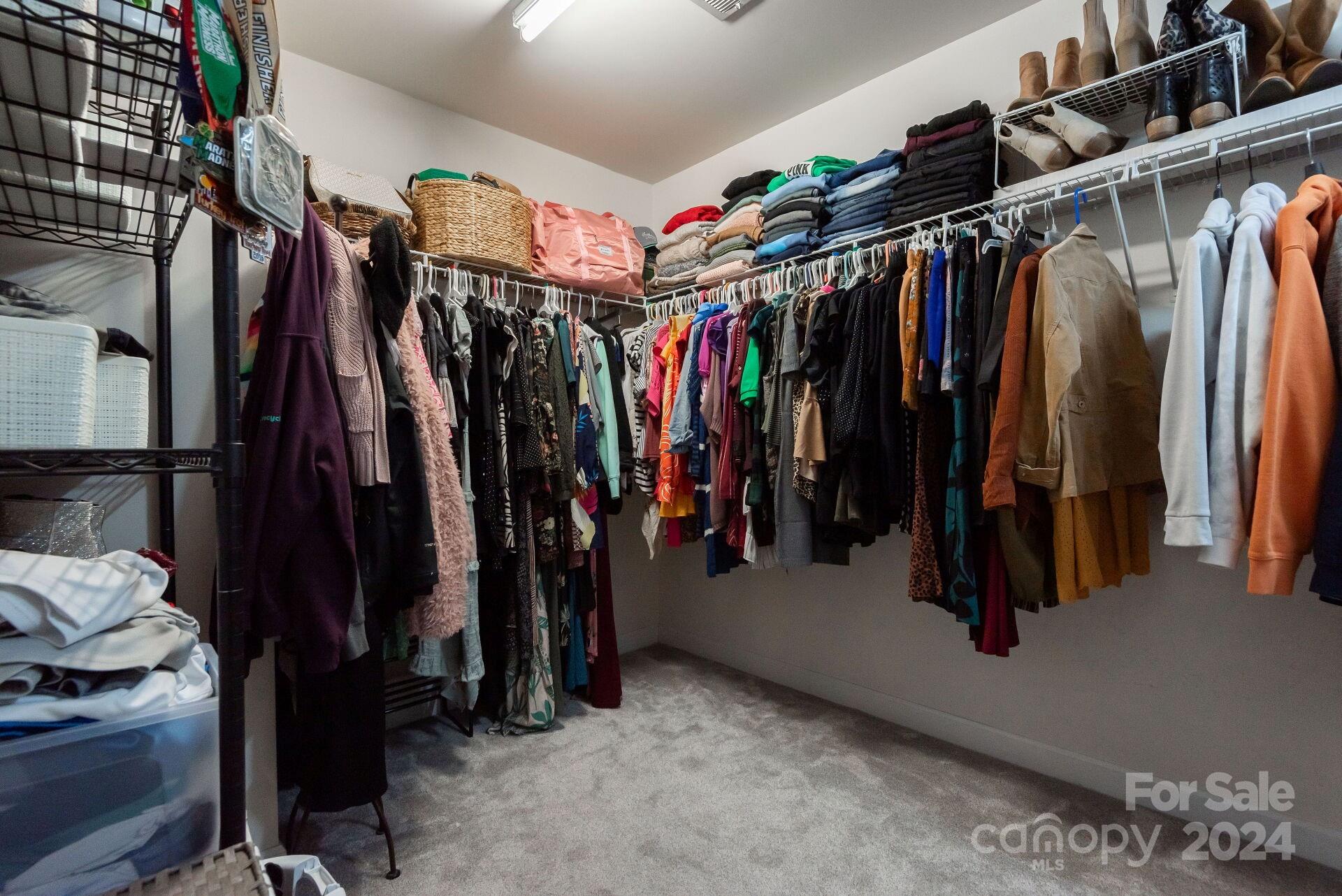 6725 Dusty Saddle Road Charlotte, NC 28277 - Photo 23 of 29 a view of walk in closet with clothes and shoes