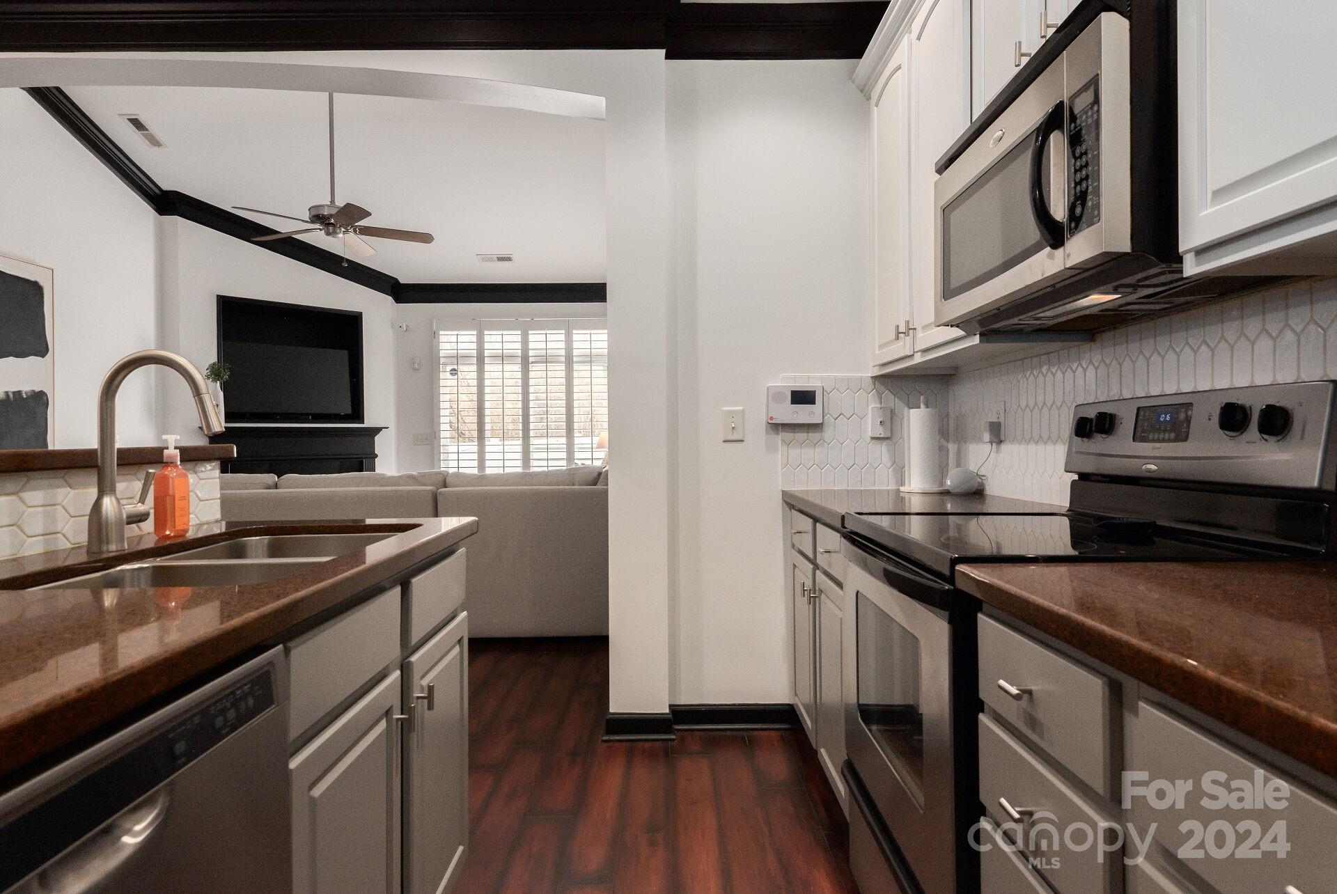 6725 Dusty Saddle Road Charlotte, NC 28277 - Photo 7 of 29 a kitchen with stainless steel appliances granite countertop a sink and stove