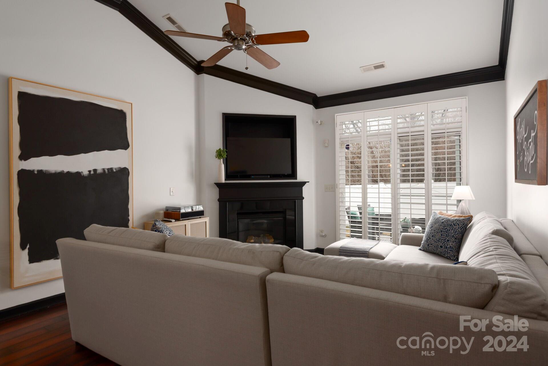 6725 Dusty Saddle Road Charlotte, NC 28277 - Photo 8 of 29 a living room with furniture a flat screen tv and a large window