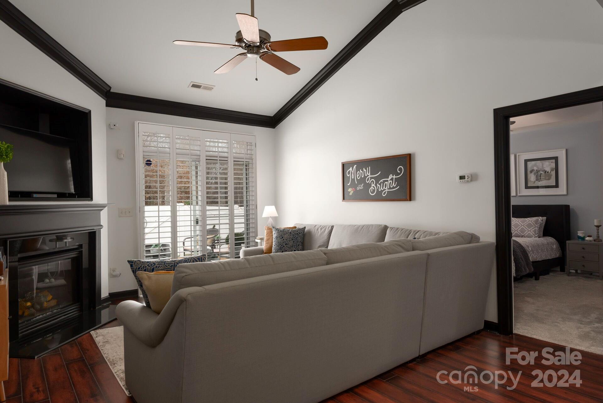 6725 Dusty Saddle Road Charlotte, NC 28277 - Photo 9 of 29 a living room with furniture a flat screen tv and a fireplace