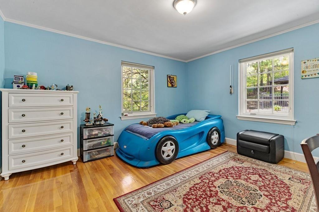 132 Beverly Road Brookline, MA 02467 - Photo 12 of 36 a bedroom with a bed and a window