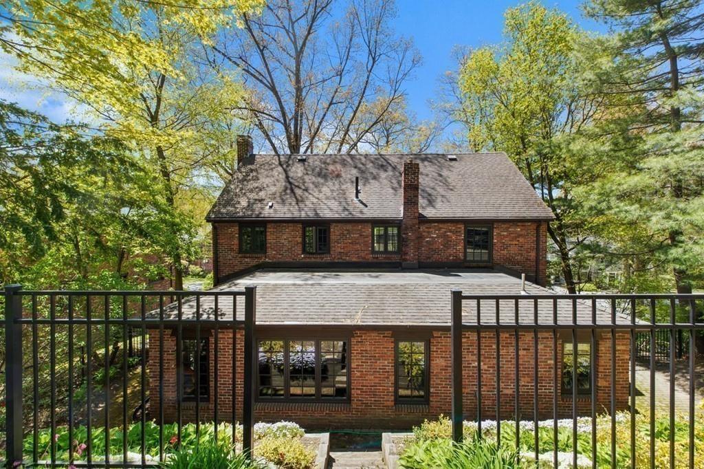 132 Beverly Road Brookline, MA 02467 - Photo 17 of 36 a front view of a house with a garden