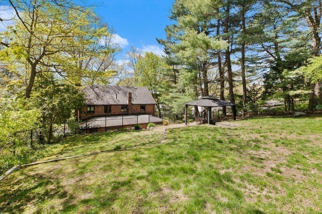 132 Beverly Road Brookline, MA 02467 - Photo 19 of 36 a backyard of a house with table and chairs