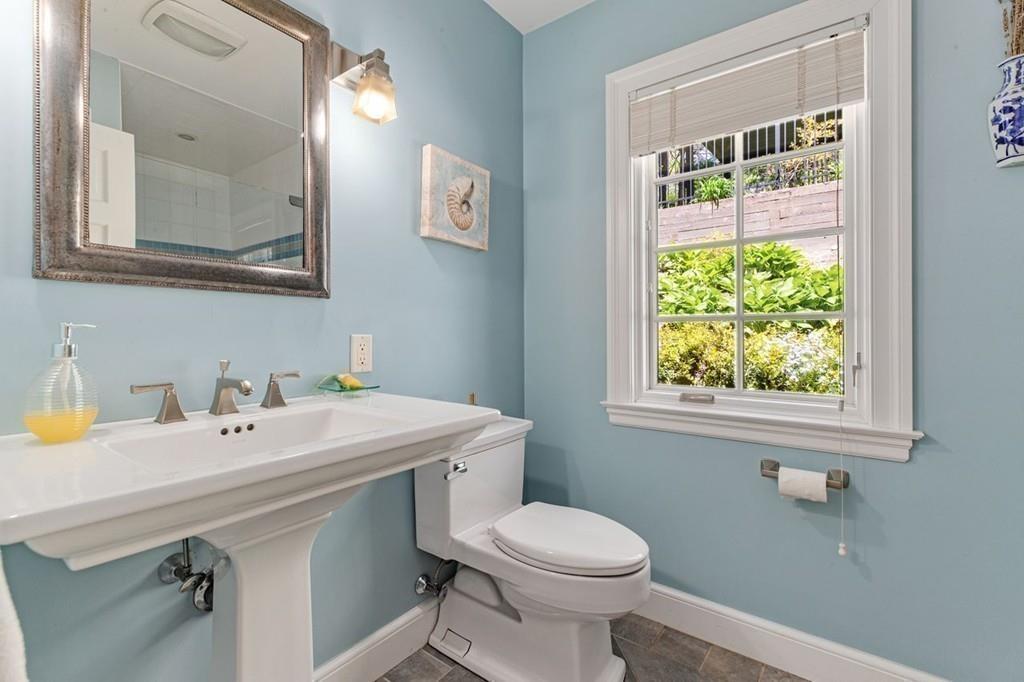 132 Beverly Road Brookline, MA 02467 - Photo 20 of 36 a bathroom with a sink a toilet and a mirror