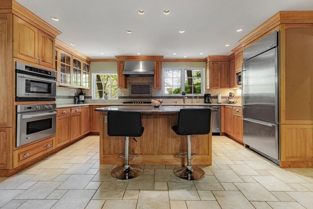 132 Beverly Road Brookline, MA 02467 - Photo 2 of 36 a kitchen with stainless steel appliances granite countertop a stove top oven a sink dishwasher and a refrigerator