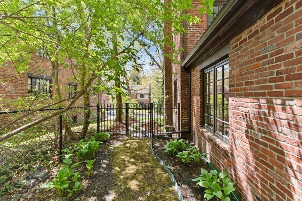 132 Beverly Road Brookline, MA 02467 - Photo 23 of 36 a view of a pathway that has a tree in front of the house