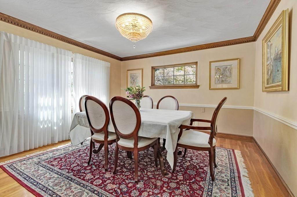 132 Beverly Road Brookline, MA 02467 - Photo 24 of 36 a view of a dining room with furniture a rug and wooden floor