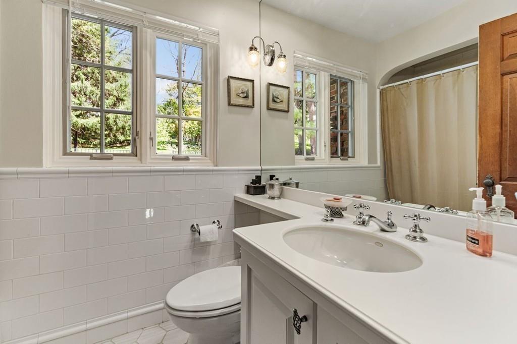 132 Beverly Road Brookline, MA 02467 - Photo 29 of 36 a bathroom with a sink a toilet and a mirror