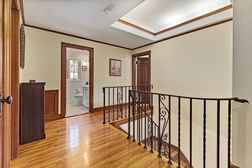 132 Beverly Road Brookline, MA 02467 - Photo 9 of 36 a view of a hallway with wooden floor and staircase