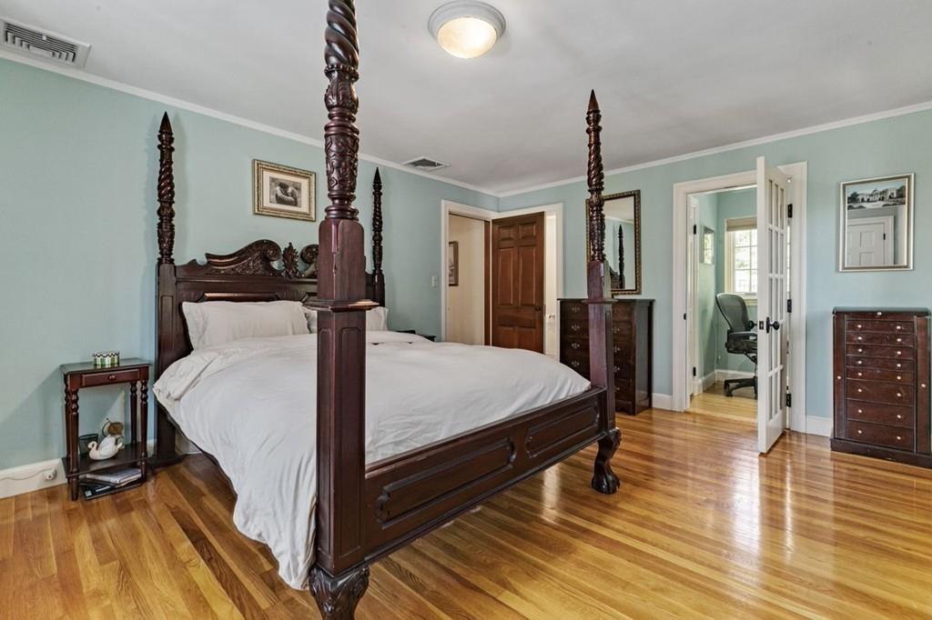132 Beverly Road Brookline, MA 02467 - Photo 10 of 36 a bed room with a bed and a chandelier
