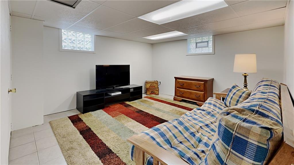 9735 Valley View Road Pittsburgh, PA 15237 - Photo 17 of 25 a bedroom with a bed and a flat screen tv