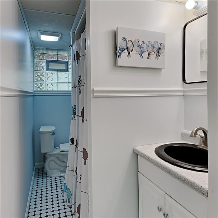 9735 Valley View Road Pittsburgh, PA 15237 - Photo 18 of 25 a bathroom with a sink a toilet and shower