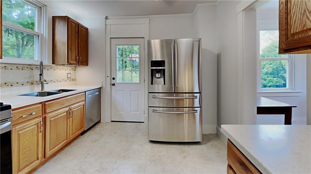 9735 Valley View Road Pittsburgh, PA 15237 - Photo 9 of 25 a kitchen with stainless steel appliances a refrigerator and a sink