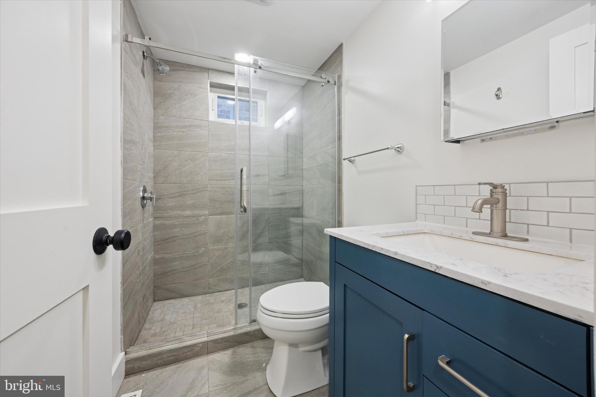 531 Mifflin Street Philadelphia, PA 19148 - Photo 13 of 28 a bathroom with a granite countertop sink a toilet and shower
