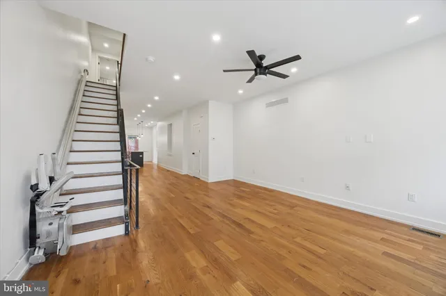 a view of a room with wooden floor and stairs