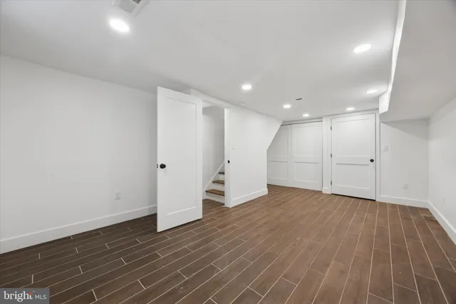 a living room with furniture a flat screen tv and a large window