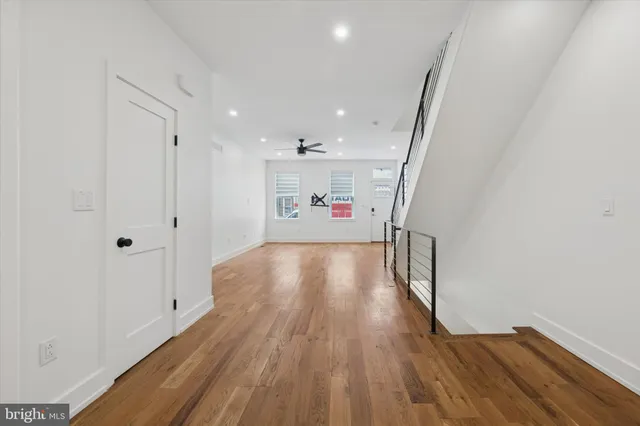 a view of a hallway with wooden floor