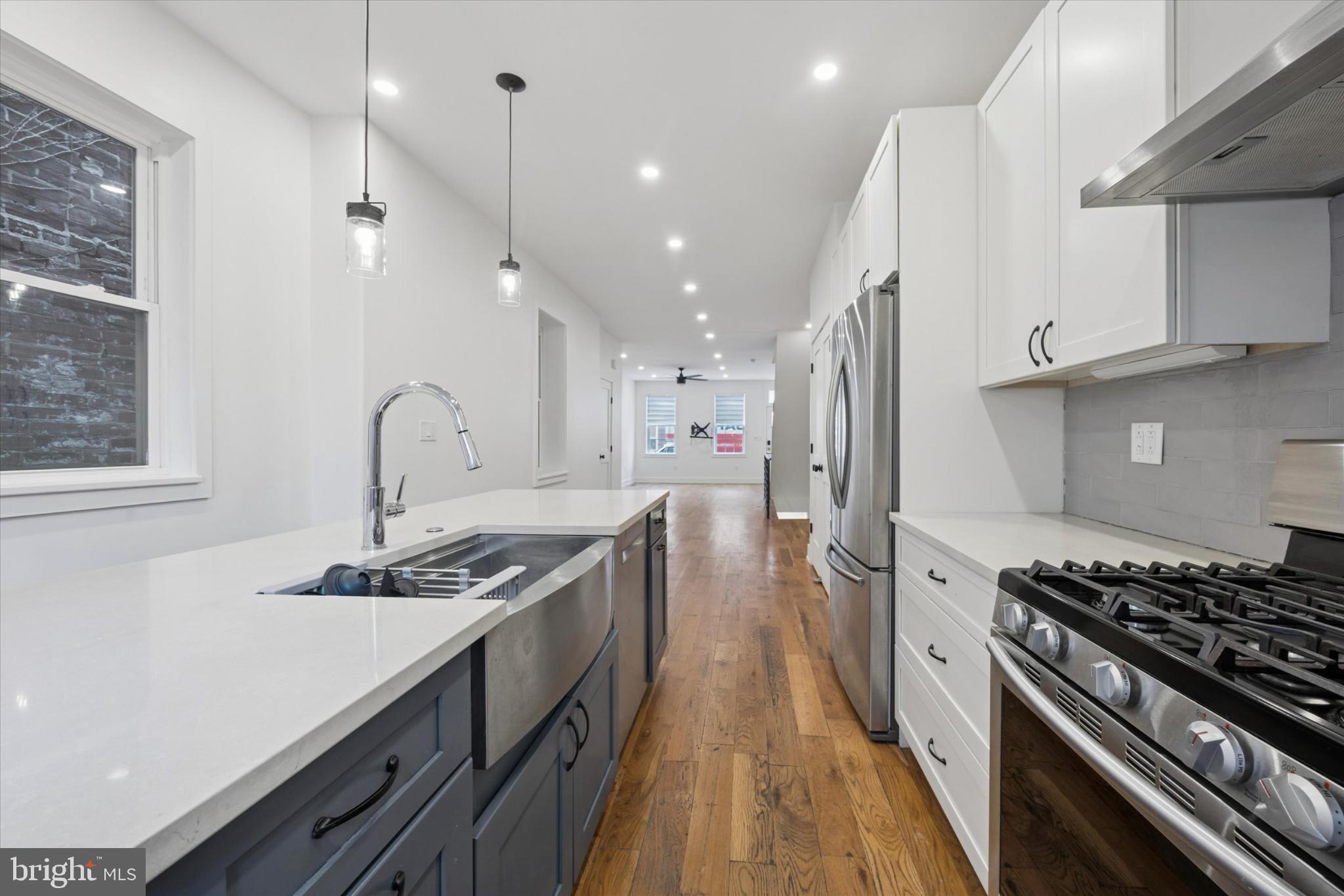 531 Mifflin Street Philadelphia, PA 19148 - Photo 10 of 28 a kitchen with stainless steel appliances granite countertop a stove a sink and a refrigerator