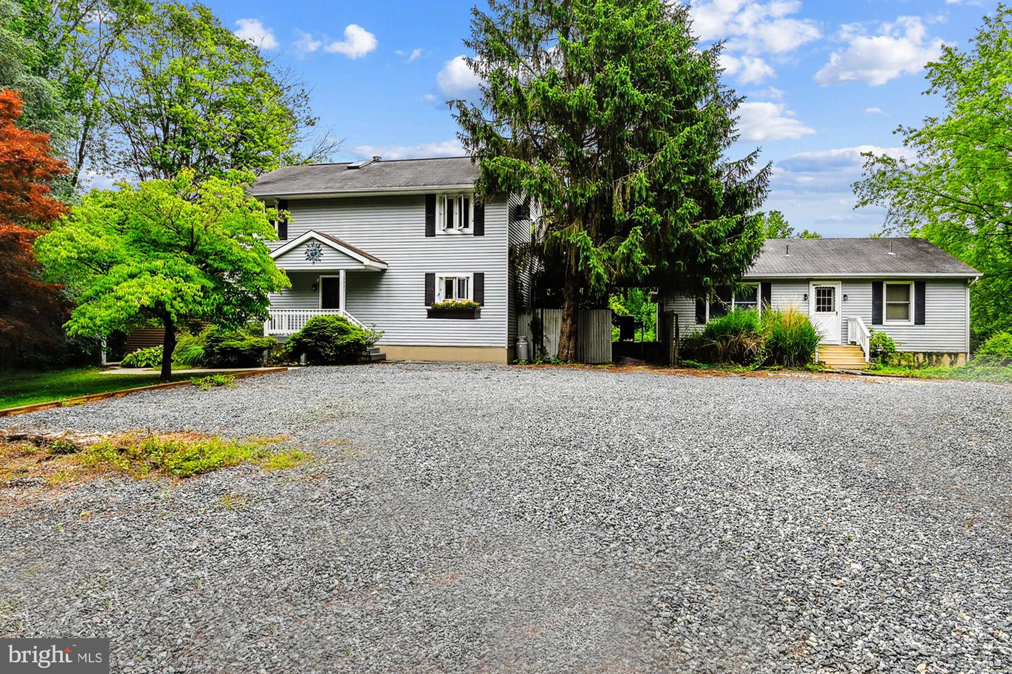 4441 Solomons Island Road Harwood, MD 20776 - Photo 2 of 87 a view of house with outdoor space and tall tree