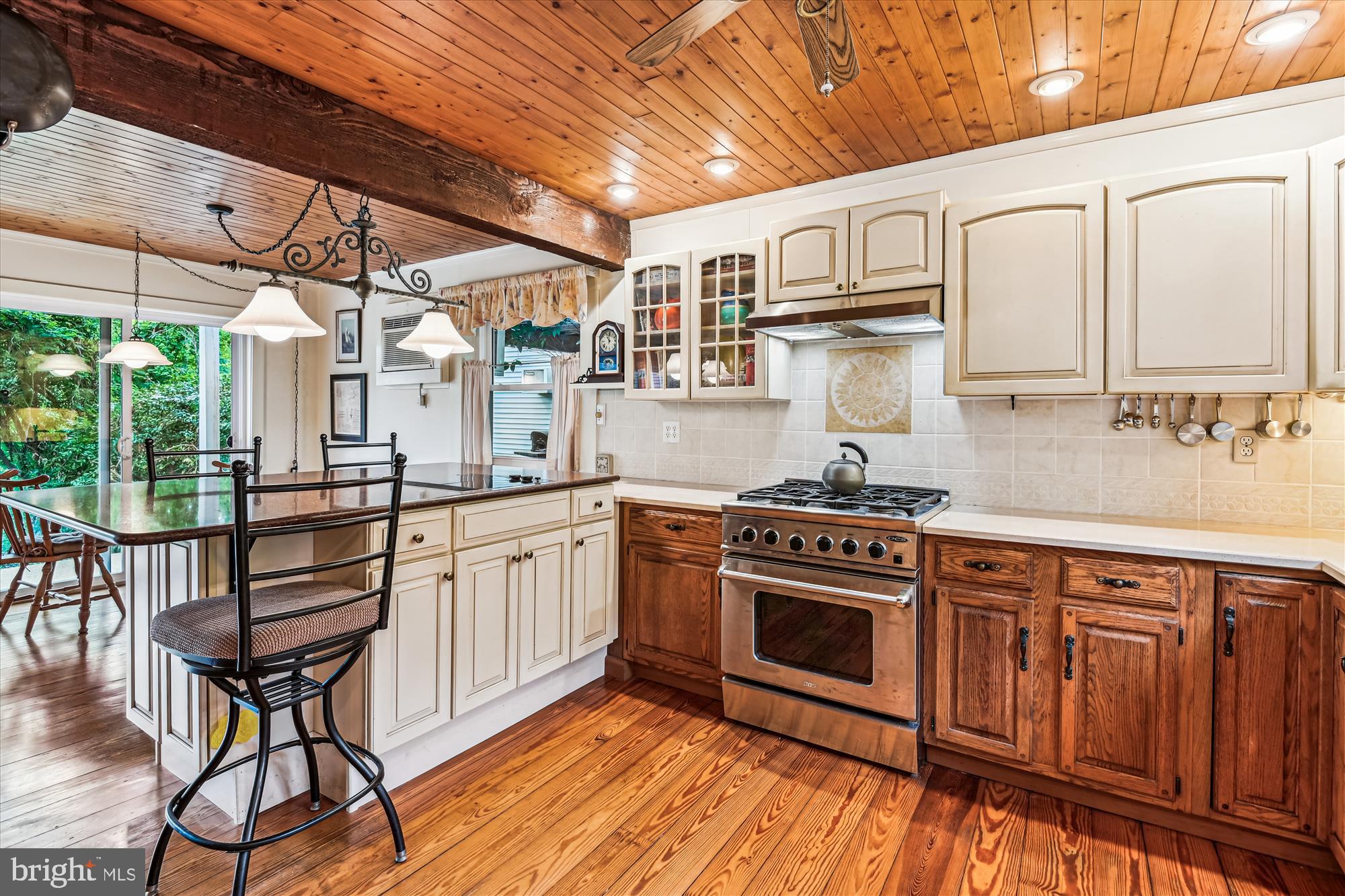 4441 Solomons Island Road Harwood, MD 20776 - Photo 31 of 87 a kitchen with stainless steel appliances granite countertop a stove a sink dishwasher and cabinets with wooden floor