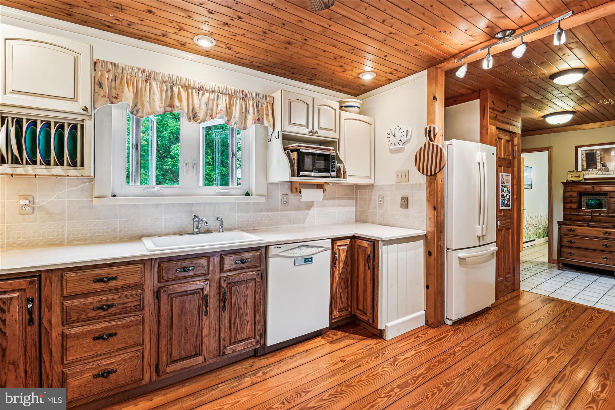 4441 Solomons Island Road Harwood, MD 20776 - Photo 33 of 87 a kitchen with a refrigerator and a sink