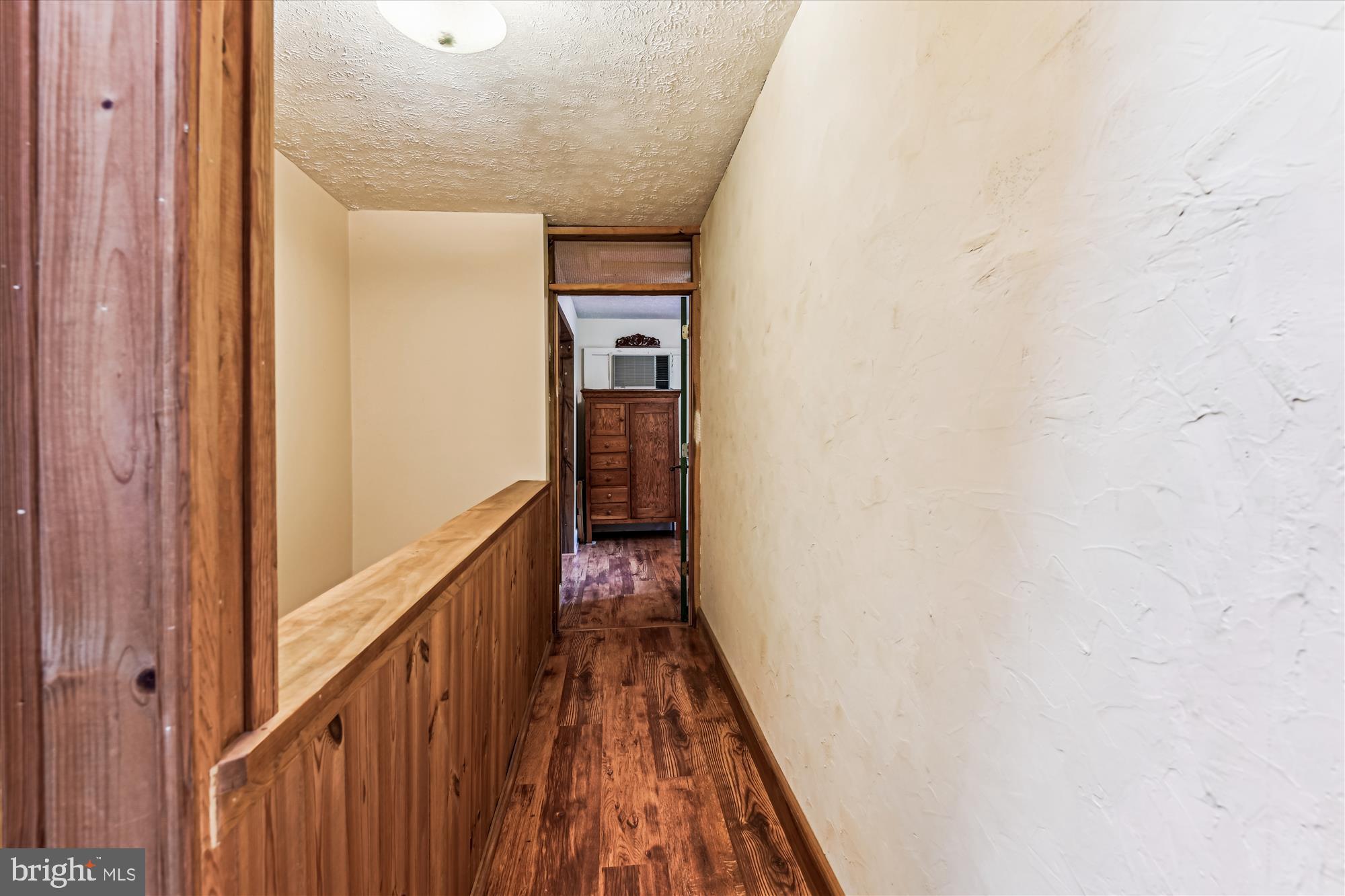 4441 Solomons Island Road Harwood, MD 20776 - Photo 51 of 87 a view of a hallway with wooden floor and staircase