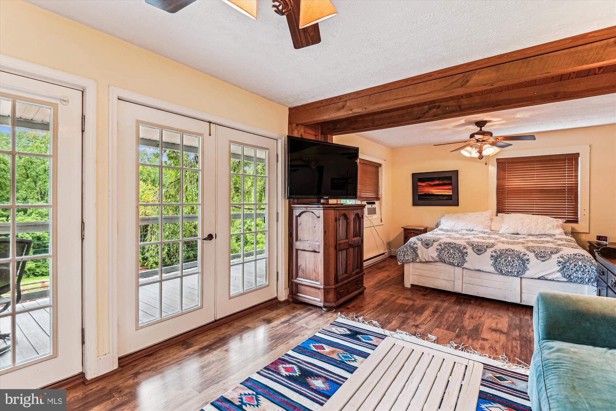 4441 Solomons Island Road Harwood, MD 20776 - Photo 55 of 87 a bedroom with a bed bookshelf and a large window