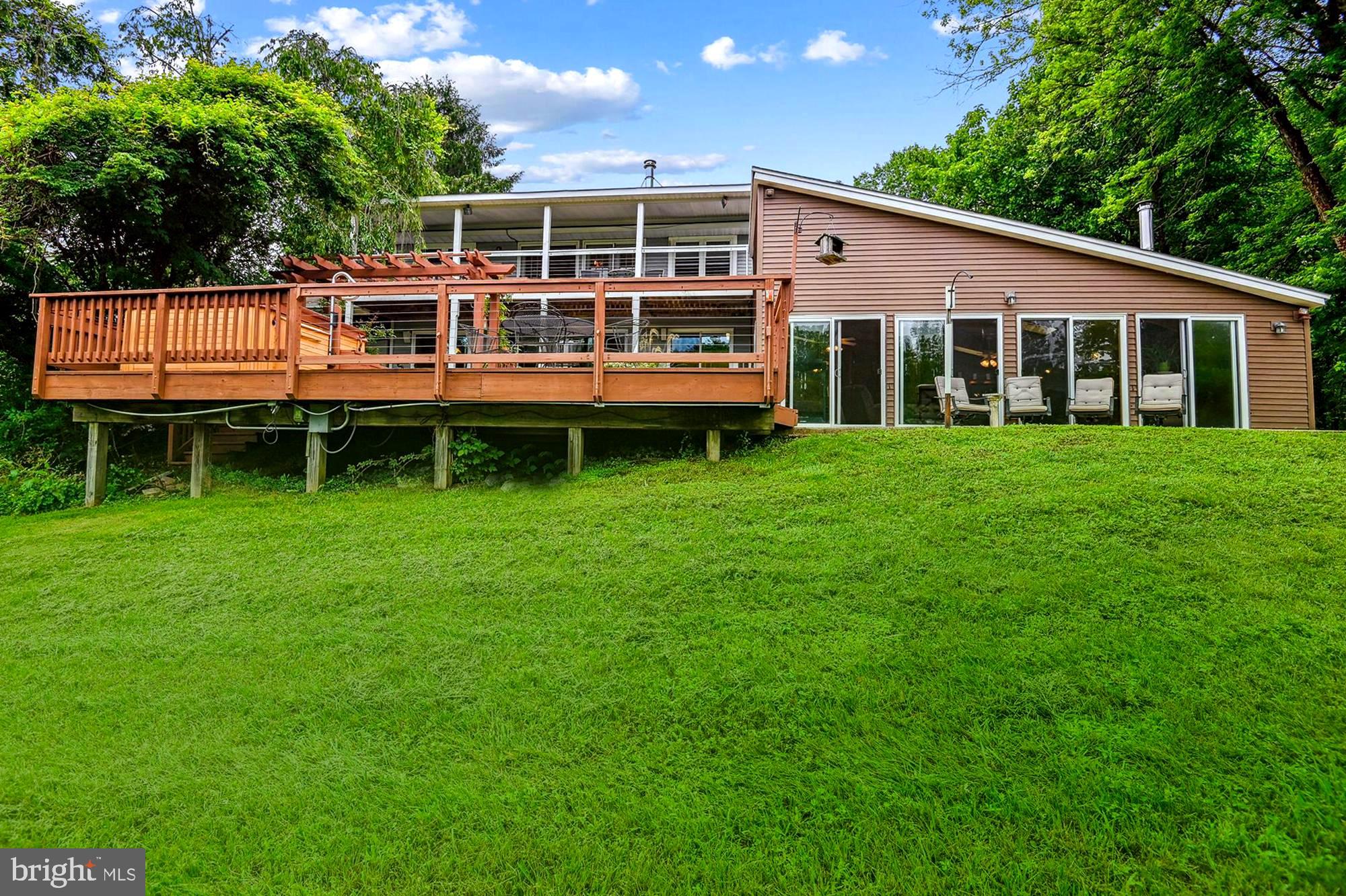 4441 Solomons Island Road Harwood, MD 20776 - Photo 6 of 87 a front view of a house with a yard table and chairs
