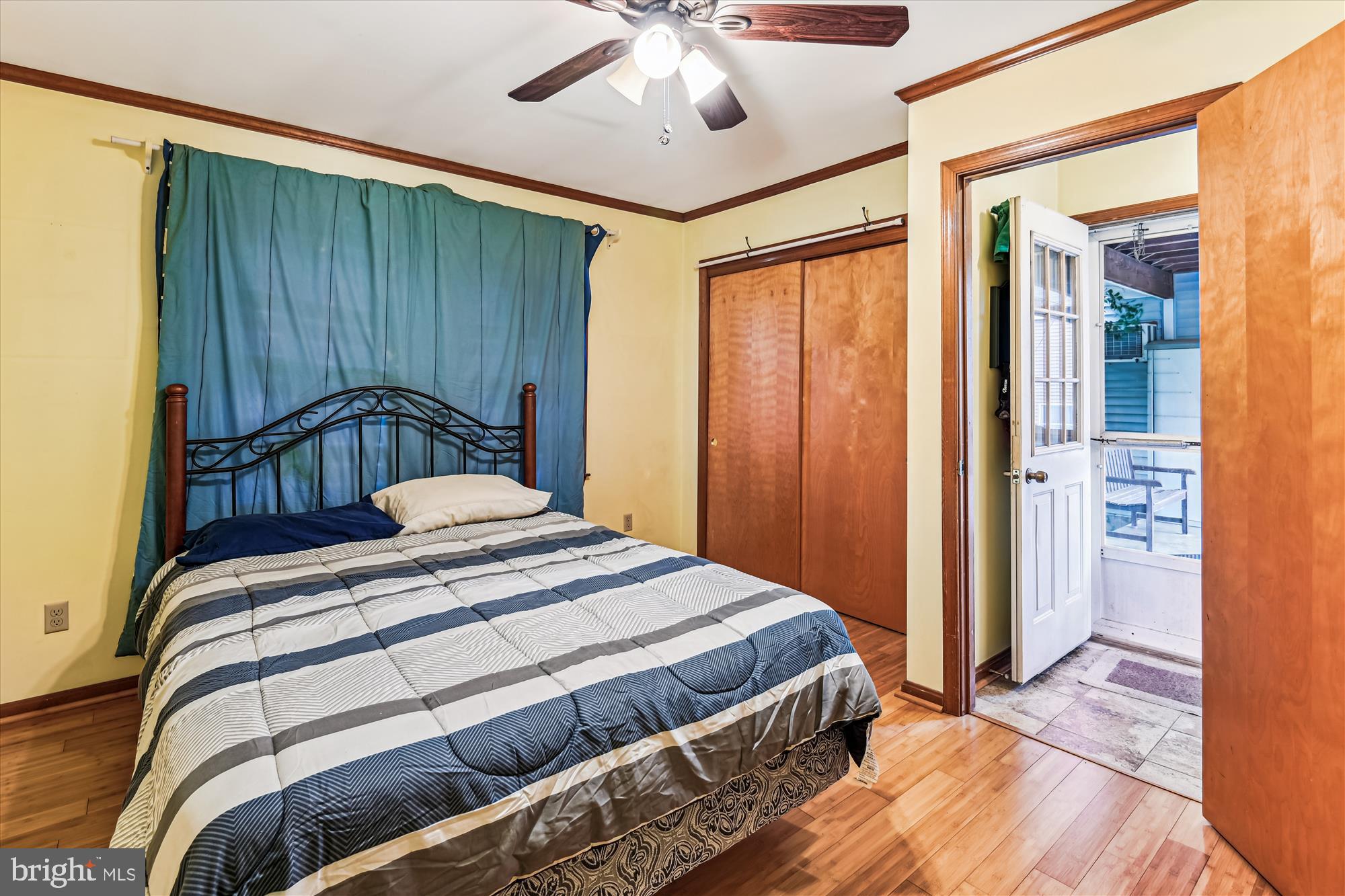 4441 Solomons Island Road Harwood, MD 20776 - Photo 72 of 87 a bedroom with a bed and a chandelier