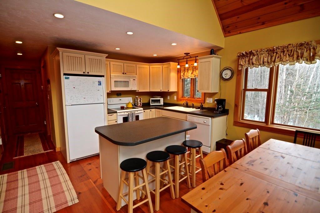 406 Paradise Road Bethel, ME 04217 - Photo 7 of 35 The kitchen features an island and...