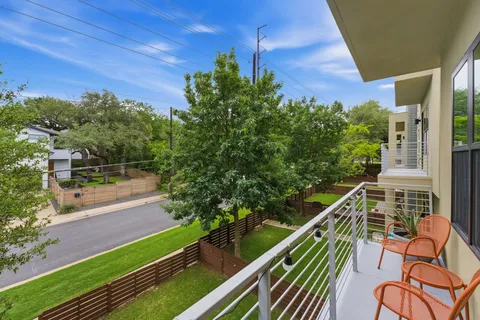 a balcony with view of an outdoor space