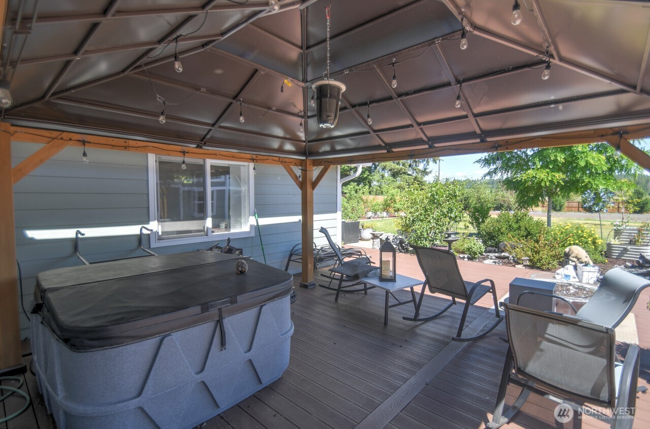 5922 184th Lane Southwest Rochester, WA 98579 - Photo 17 of 34 a view of a patio with table and chairs under an umbrella