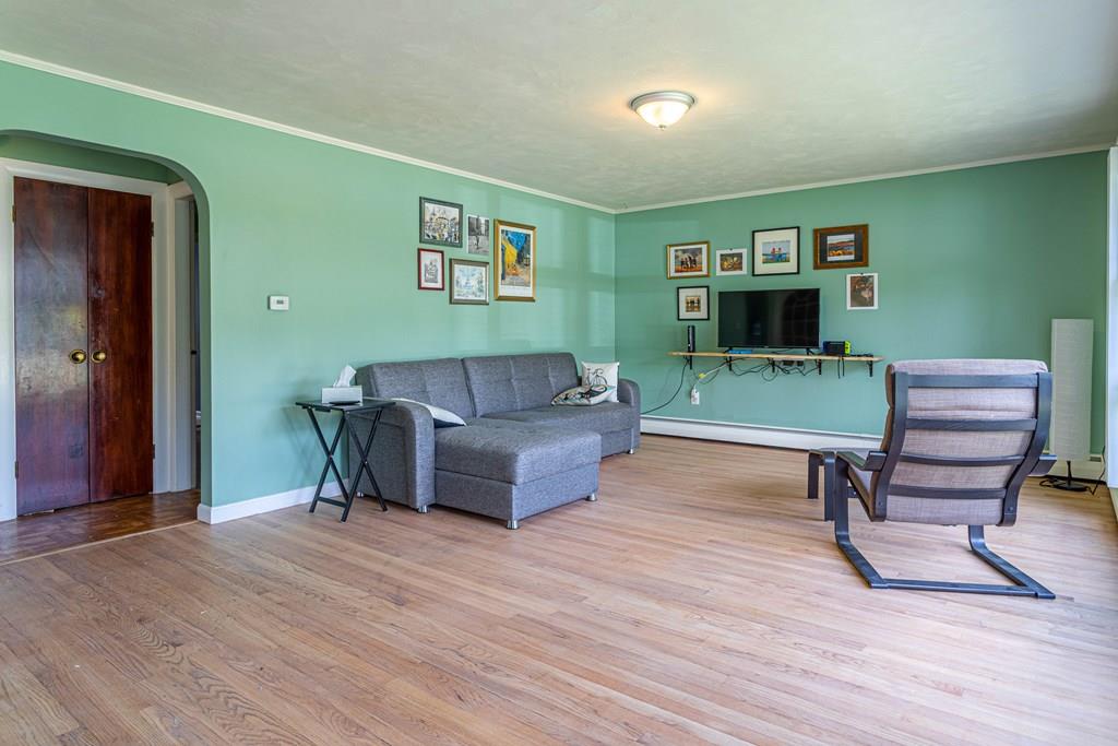 202 Whalom Road Lunenburg, MA 01462 - Photo 11 of 42 a living room with furniture and a wooden floor